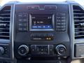 A 2019 Ford F-350 SD dashboard featuring a radio display with buttons for media control and climate settings