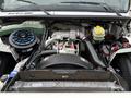 Engine compartment of a 2005 Freightliner M2 106 displaying the engine assembly with various components including the air filter and coolant reservoir