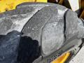 Close-up of a worn tire from a 2011 John Deere 310SJ showcasing the tread pattern and texture of the rubber surface