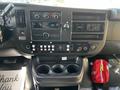 Interior dashboard of a 2019 Chevrolet Express with various control knobs buttons and a radio display