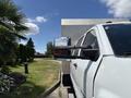 A 2020 Chevrolet Silverado with a side mirror reflecting light and featuring a rugged design with prominent wheel arches and chrome accents