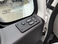 A control panel featuring four buttons for operating the windows and locks of a 2014 International TerraStar vehicle