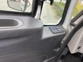 Interior view of a 2014 International Durastar truck showing the door panel with controls and a storage compartment