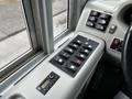 A control panel of a 2015 Spartan School Bus featuring multiple switches and buttons for various operations