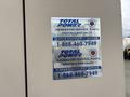 A metal plate with blue and silver branding labeled Total Power featuring contact information for generator service parts rentals and sales