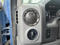 Close-up of the dashboard controls of a 2010 Ford Econoline including the air vent knob and light control switch
