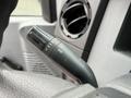 A close-up of the turn signal lever on the steering column of a 2012 Ford F-450 SD