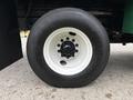 Close-up of a large black tire mounted on a white rim, part of a 2015 Freightliner M2 106 truck