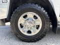 A close-up of a chrome wheel on a 2020 Ram 2500 featuring a Toyo Open Country M/T tire with an aggressive tread pattern