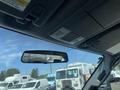 Interior view of a 2015 Ford F-550 showing the overhead console and rearview mirror with other trucks visible outside the windshield