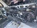 A 2013 Ford Expedition with the interior stripped down showing the dashboard components and wiring exposed