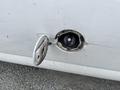 Close-up of the fuel filler cap of a 2014 GMC Savana showing the cap inside the open fuel door