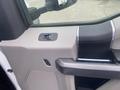 Interior door panel of a 2017 Ford F-550 featuring a window control switch and a door handle