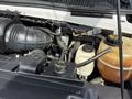 View of the engine compartment of a 2010 Ford Econoline showing the air intake and various fluid reservoirs