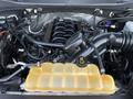 The engine compartment of a 2016 Ford F-150 showing the engine block along with various components and a yellow coolant reservoir