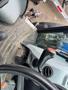 View of the interior controls of a 2016 New Holland T475 tractor with a gearshift lever and foot pedals in focus