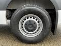 A close-up of a wheel from a 2021 Mercedes-Benz Sprinter featuring a silver multi-spoke rim and a black tire with the brand name Michelin visible