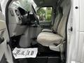 Interior of a 2017 Ford Econoline showing two front seats and a dashboard with steering wheel and control panel