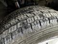 Close-up of a worn tire from a 2020 Ford Transit showing visible tread patterns and debris on the surface