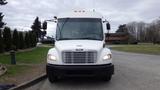 A white 2016 Ford Transit van with a large windshield and multiple front lights visible