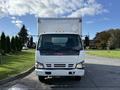 2007 GMC W5500 18 foot cube van parked facing forward with a white exterior and visible GMC branding on the front