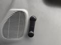 A black door handle next to a silver air vent on the interior panel of a 2007 Ford F-550