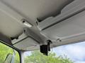 Interior overhead view of a 2018 Hino 195 featuring storage compartments and a mounted device