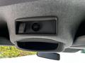 A 2017 Mercedes-Benz Sprinter interior overhead console featuring a small storage compartment and a power outlet