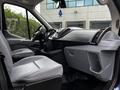 Interior view of a 2017 Ford Transit 350 showcasing a driver's seat and dashboard with controls and storage compartments