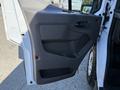 Interior door panel of a 2022 Ford Transit featuring a textured gray surface and controls for windows and locks
