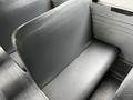 Interior seat of a 2015 Spartan school bus with gray vinyl upholstery and a textured surface