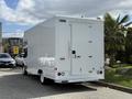 A white 2016 Ford Transit cargo van is parked with a closed rear door and a smooth exterior design