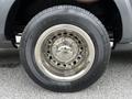 Close-up of a chrome alloy wheel with a Firestone tire on a 2017 Ford Transit 350