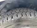 Close-up of a rugged tire tread on a 2020 Chevrolet Express showing deep grooves and a thick rubber profile designed for traction and durability