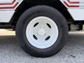 A close-up of a white wheel on a 2019 Ford Econoline featuring a simple five-bolt design and a black tire with tread visible