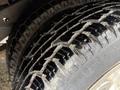 Close-up of a rugged tire from a 2007 Ford E-350 showing detailed tread pattern and some dirt on the surface