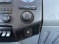 The interior dashboard controls of a 2012 Ford F-350 SD featuring various buttons knobs and an auxiliary input port