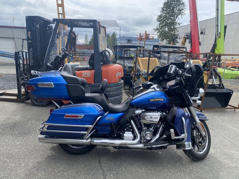 A blue 2017 Harley-Davidson FLHTKL motorcycle with a touring design featuring saddlebags and a windshield