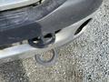 A close-up of the front bumper of a 2009 Dodge Ram 5500 showing a tow hitch receiver and a hook attachment