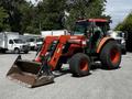A 2011 Kubota M8540D tractor with a front loader attachment featuring large tires and a bright orange and black color scheme