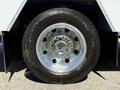 Close-up of a chrome wheel on a 2024 Ford F-550 Super Duty featuring a Continental tire and a polished rim
