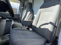Interior of a 2019 Ford Econoline showing two gray fabric seats with armrests and a simple dashboard design
