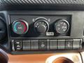 Dashboard controls of a 2021 Hino 338 featuring air conditioning settings and multiple buttons for various functions