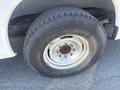 Close-up of the wheel and tire of a 2007 Chevrolet Express showing the rim and worn tread of the tire