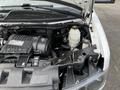 An open hood of a 2017 Chevrolet Express revealing the engine compartment with various components including the engine block and coolant reservoir