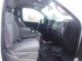 A 2015 Chevrolet Silverado 1500 interior showing front seats with gray upholstery and a center console in between