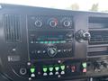 Dashboard of a 2017 Chevrolet Express featuring climate control dials a radio display and various buttons and switches for vehicle functions