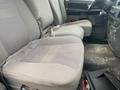 Interior of a 2008 Dodge Ram 5500 showing gray fabric seats with some wear and a floor with scattered debris