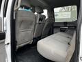 Interior view of a 2017 Ford F-550 showing gray upholstery with two rear seats and a middle seat option