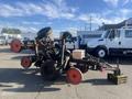 A 2017 R&R Reel with a wheel assembly and a metal frame positioned upright with visible tires and a small box on the platform